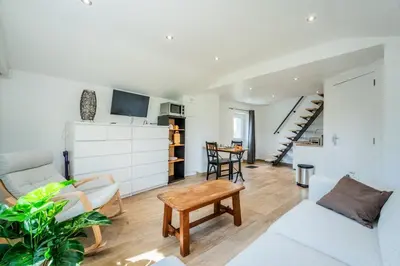 a living room with a couch and a table at L étage in Soumagne