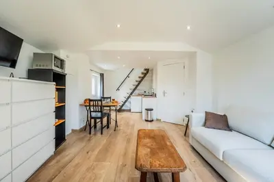 a living room with a couch and a table at L étage in Soumagne