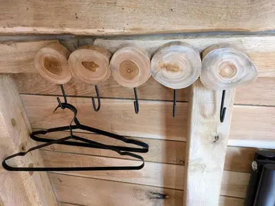 a group of wooden rings hanging on a wall at la pomme de pin Cornesse