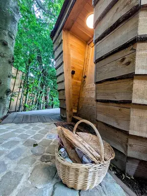 a basket of rocks sitting next to a wooden wall at la pomme de pin Cornesse