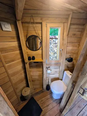 a small bathroom with a toilet and a mirror at la pomme de pin Cornesse