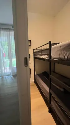 a room with two bunk beds and a doorway at vakantie-hengelhoef in Houthalen-Helchteren