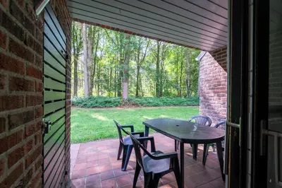 a patio with a table and chairs on it at vakantie-hengelhoef in Houthalen-Helchteren