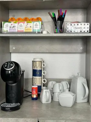 a kitchen shelf with a coffee maker and other kitchen items at Chambre de luxe Afrik a Liège Grande Sale de bain privée check in autonome cuisine partagée in Liège