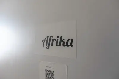 a sign on a wall with the word africa on it at Chambre de luxe Afrik a Liège Grande Sale de bain privée check in autonome cuisine partagée in Liège