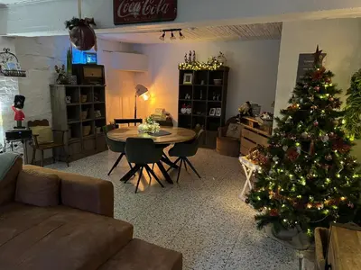 a living room with a christmas tree and a table at La maison de MiLy in Bassenge