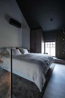 a bedroom with a large bed and a window at Suite Escape in Hasselt