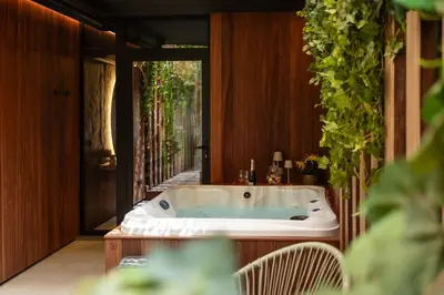 a jacuzzi tub in the middle of a house at Suite Escape in Hasselt