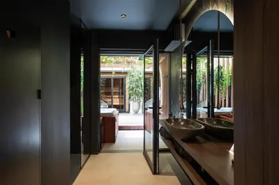 a bathroom with two sinks and a mirror at Suite Escape in Hasselt