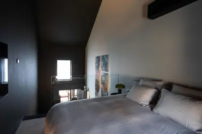 a bedroom with a bed and a window at Suite Escape in Hasselt