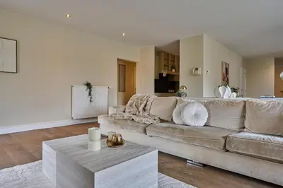 a living room with a couch and a table at Aurora City Apartment in Lommel