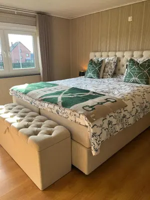 a bedroom with a large bed and a window at 't Steenenhuys in Dilsen-Stokkem