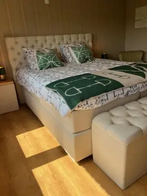 a bedroom with a bed with a football blanket on it at 't Steenenhuys in Dilsen-Stokkem