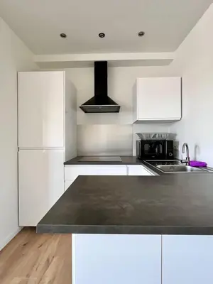 a kitchen with white cabinets and a stove top oven at Cozy and fully equipped in the center of Liege 4 guests in Liège