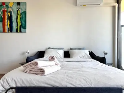 a bedroom with a bed with towels on it at Cozy and fully equipped in the center of Liege 4 guests in Liège