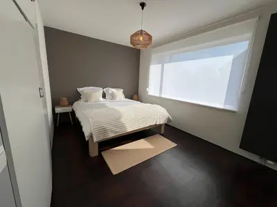 a small bedroom with a bed and a window at Casa Sahara - 8 guests - near nature reserve in Lommel