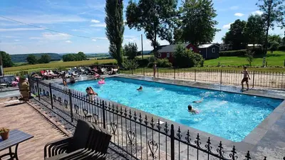 a group of people swimming in a swimming pool at Camping Natuurlijk Limburg - Chalet 4 in Voeren