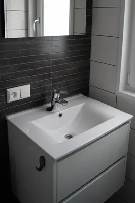 a bathroom with a white sink and a mirror at Chalet - Camping Natuurlijk Limburg in Voeren