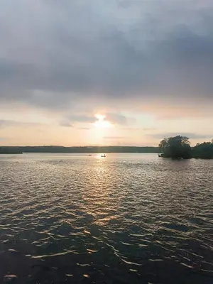 a sunset over a large body of water at Oseraie Cabins - Wild lodges près de Maastricht in Visé