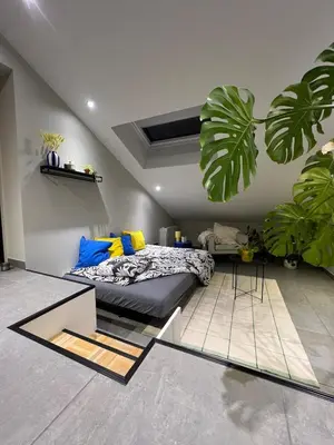 a bedroom with a bed and some plants in it at Studio SC - Cozy appartement in Genk near Thor Park - 4 people in Genk