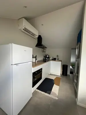 a kitchen with white appliances and a white refrigerator at Studio SC - Cozy appartement in Genk near Thor Park - 4 people in Genk