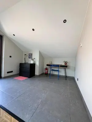 an attic room with a table and a desk at Studio SC - Cozy appartement in Genk near Thor Park - 4 people in Genk