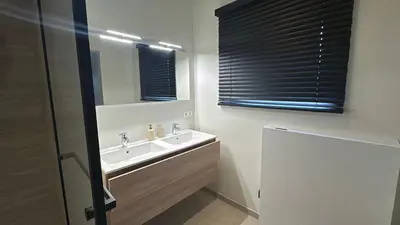 a bathroom with a sink and a mirror at Inspire Residence and private Wellness in Tongeren