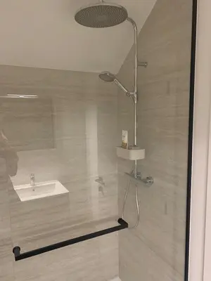 a shower with a sink and a shower head at Inspire Residence and private Wellness in Tongeren