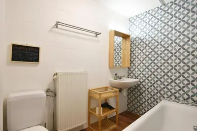 a bathroom with a toilet and a sink at La petite Naimette in Liège