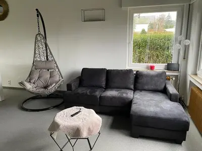 a living room with a couch and a swing at Villa les Hauts de Heusy in Verviers