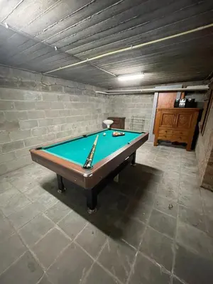 a room with a pool table in a basement at Villa les Hauts de Heusy in Verviers