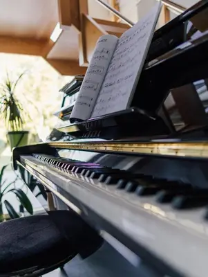 a piano with a book on top of it at Le Surdan in Bassenge