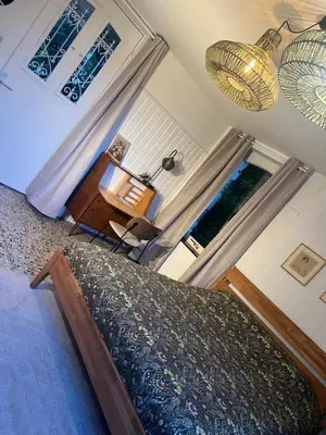 a bedroom with a large bed and a window at Chez Léopold in Verviers