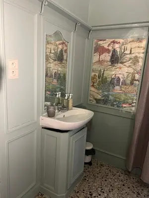 a bathroom with a sink and a painting on the wall at Chez Léopold in Verviers