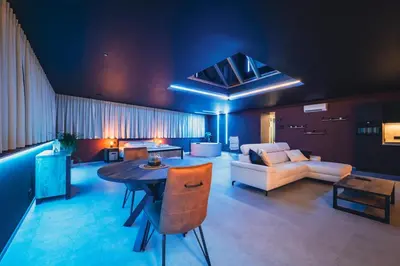 a living room with a table and a couch at Suite Soma in Bassenge