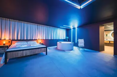 a bedroom with a large bed and a bath tub at Suite Soma in Bassenge