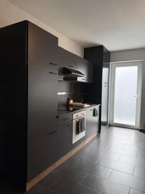 a kitchen with stainless steel appliances and a window at Urban Cocoon in Liège