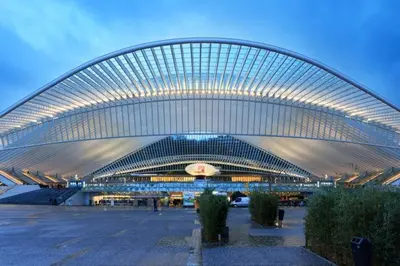 a large building is lit up at night at Urban Cocoon in Liège