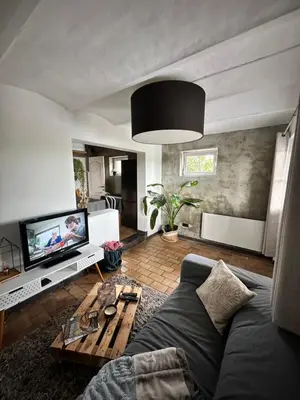 a living room with a couch and a flat screen tv at Studio 94 in Welkenraedt