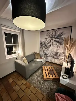 a living room with a couch and a coffee table at Studio 94 in Welkenraedt