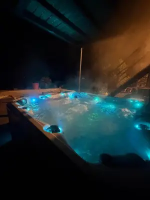 a hot tub with blue lights in a dark room at Studio 94 in Welkenraedt
