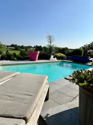 a swimming pool with a bench in a yard at Studio 94 in Welkenraedt