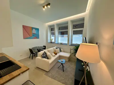 a living room with a couch and a table at L éclipse - Luxe moderniste en plein cœur de Liège in Liège