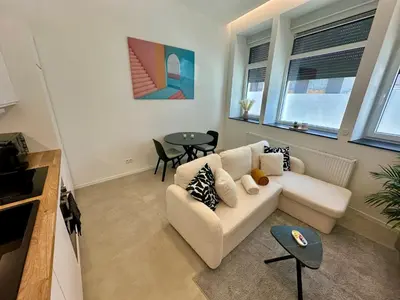 a living room with a couch and a table at L éclipse - Luxe moderniste en plein cœur de Liège in Liège