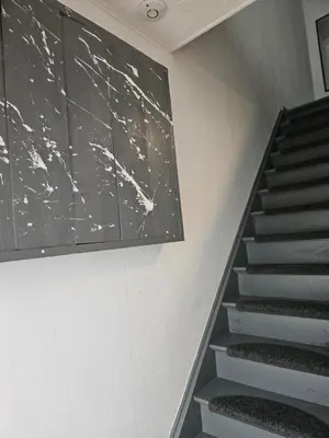 a staircase with a chalkboard on the wall and a stair case at Bianca's vakantiehuis in Houthalen-Helchteren