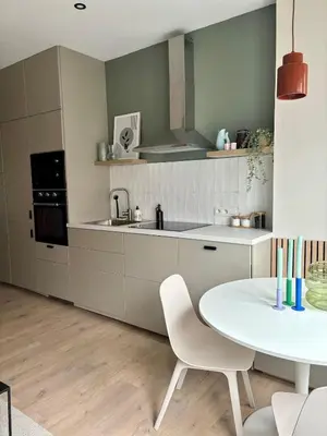 a kitchen with a white table and a sink at Studio Auguste in Liège
