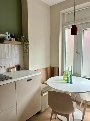 a small kitchen with a white table and chairs at Studio Auguste in Liège