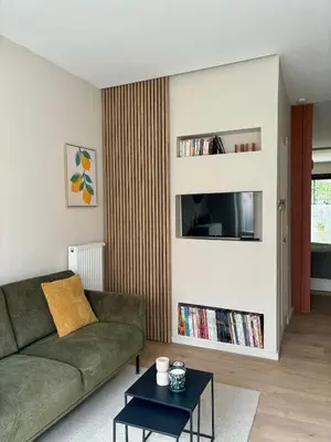 a living room with a couch and a tv at Studio Auguste in Liège