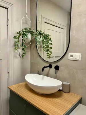 a bathroom with a white sink and a mirror at Studio Auguste in Liège