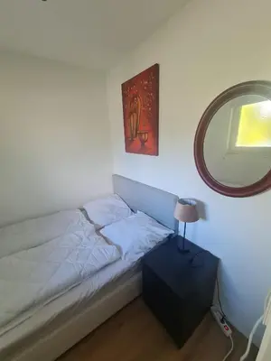 a small bedroom with a bed and a mirror at Pause Nature N in La Calamine